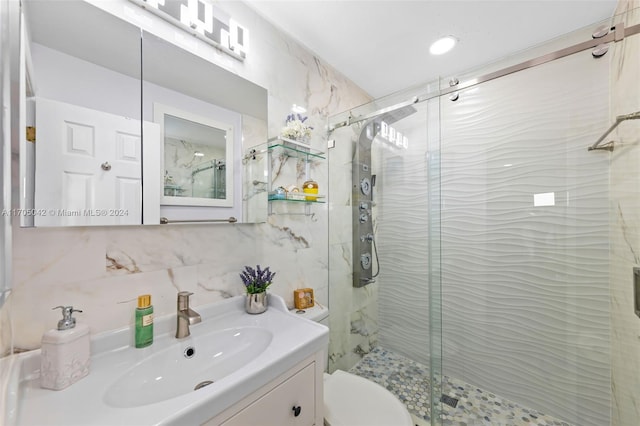 bathroom with backsplash, vanity, a shower with shower door, and toilet