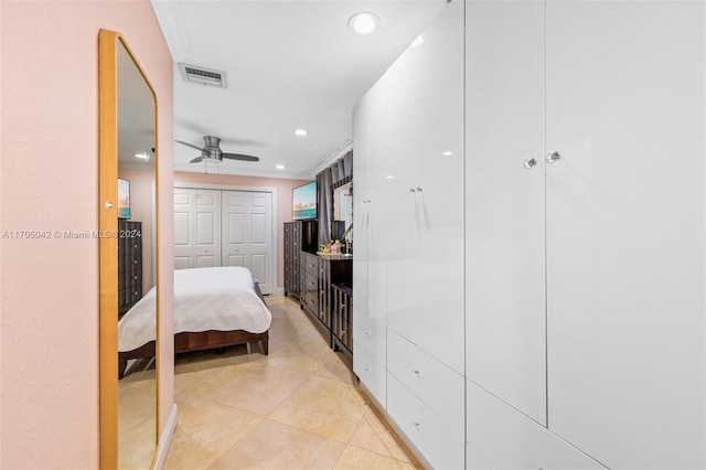 tiled bedroom featuring ceiling fan