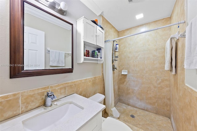 bathroom with vanity, curtained shower, toilet, and tile walls