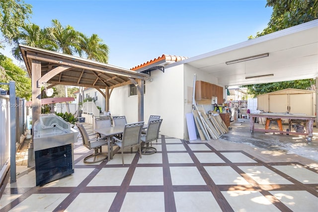 view of patio featuring grilling area and a storage shed