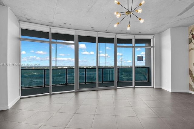 spare room with expansive windows and a notable chandelier