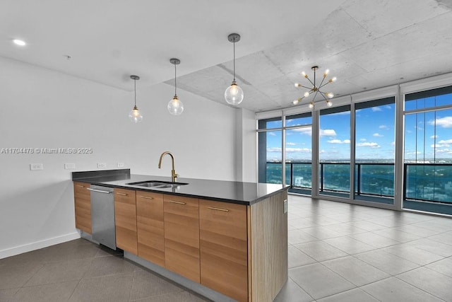 kitchen with sink, hanging light fixtures, expansive windows, stainless steel dishwasher, and light tile patterned flooring