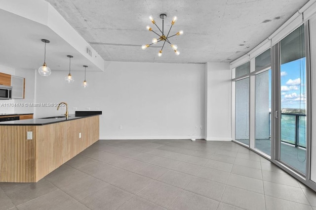 kitchen featuring a notable chandelier, decorative light fixtures, and sink