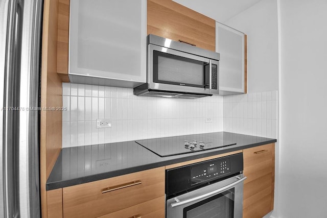 kitchen featuring backsplash and stainless steel appliances