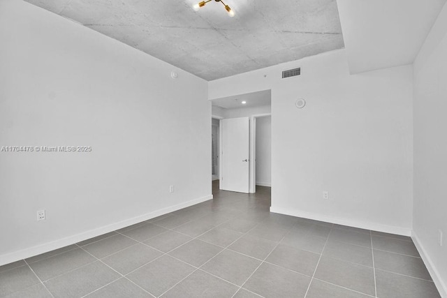 unfurnished room featuring tile patterned floors