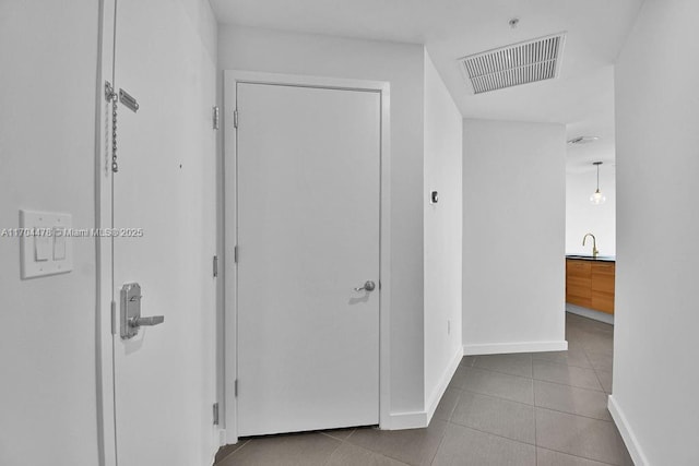 hall featuring light tile patterned flooring