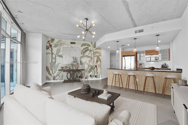 living room with a chandelier and a healthy amount of sunlight