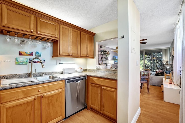 kitchen with dishwasher, sink, light hardwood / wood-style flooring, ceiling fan, and a textured ceiling