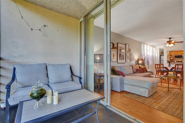 living room featuring hardwood / wood-style floors and ceiling fan