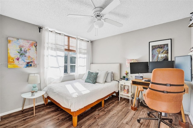 bedroom featuring hardwood / wood-style flooring, ceiling fan, and a textured ceiling