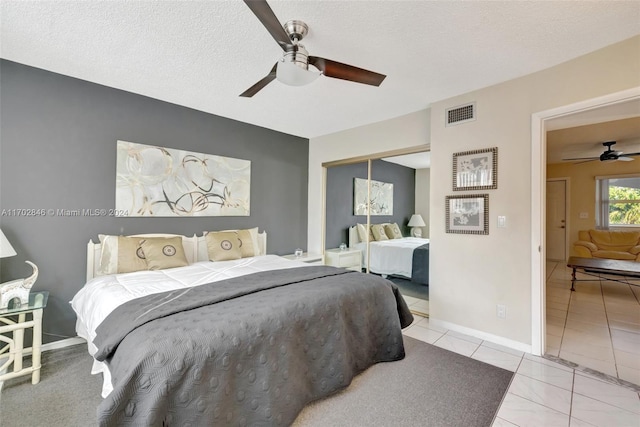 bedroom with a textured ceiling, a closet, and ceiling fan