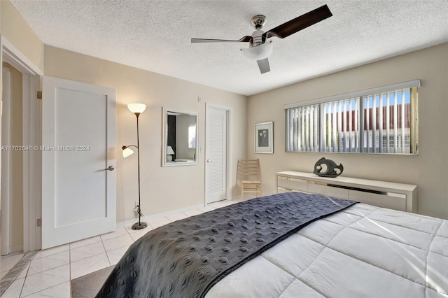 bedroom with a textured ceiling, a closet, and ceiling fan