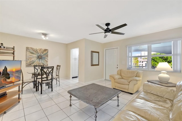 living room featuring ceiling fan and light tile patterned floors