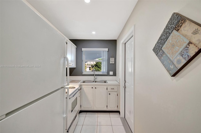 kitchen with white cabinetry, white appliances, sink, and light tile patterned floors