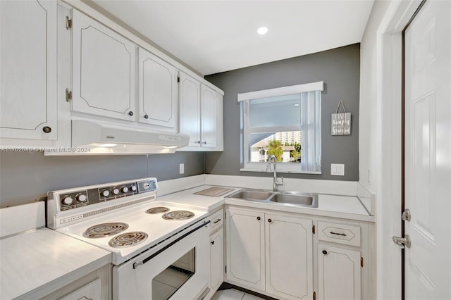 kitchen featuring electric range, sink, and white cabinets