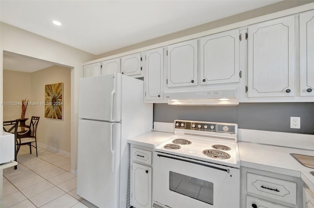 kitchen featuring light tile patterned floors, white cabinets, and white appliances