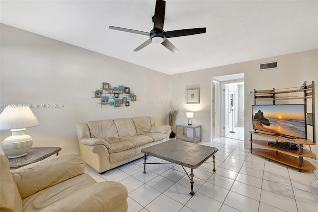 tiled living room with ceiling fan