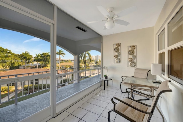 sunroom featuring ceiling fan