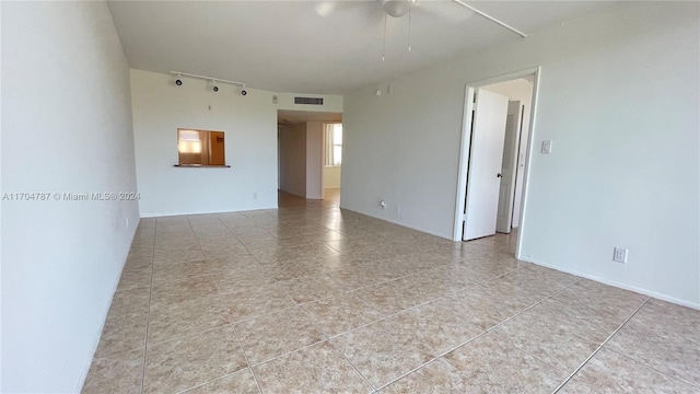 unfurnished room featuring ceiling fan and light tile patterned floors