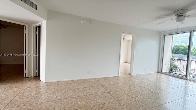 spare room with ceiling fan and light tile patterned flooring