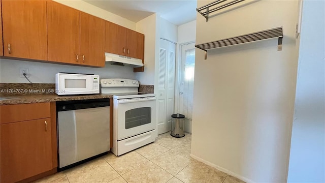 kitchen with light tile patterned flooring and white appliances