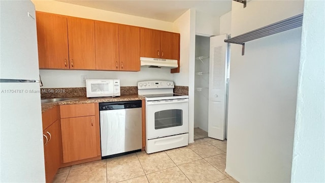 kitchen featuring light tile patterned floors and white appliances