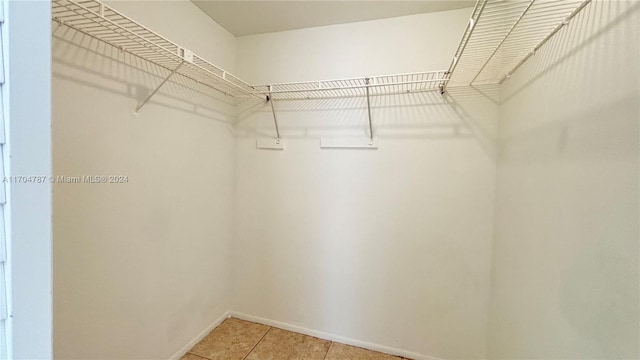 walk in closet featuring tile patterned flooring