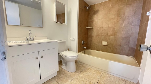 full bathroom featuring toilet, tile patterned flooring, vanity, and tiled shower / bath