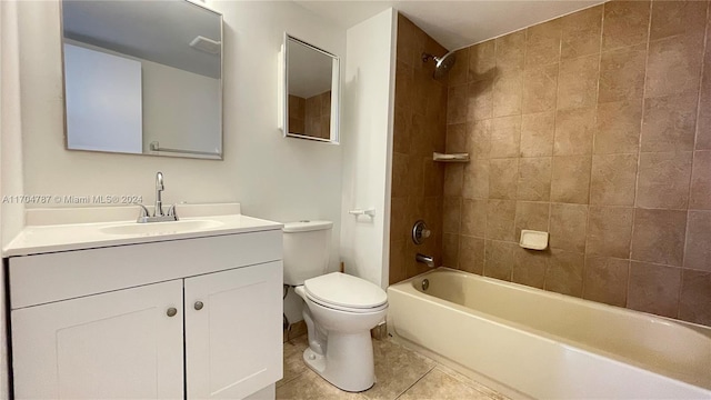 full bathroom featuring tile patterned floors, vanity, toilet, and tiled shower / bath