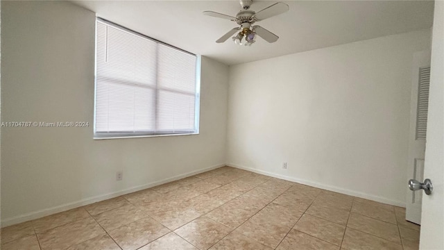 spare room featuring ceiling fan and light tile patterned flooring