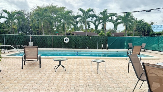 view of swimming pool featuring a patio area