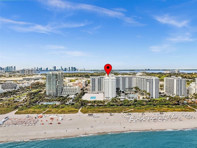 bird's eye view featuring a water view and a beach view