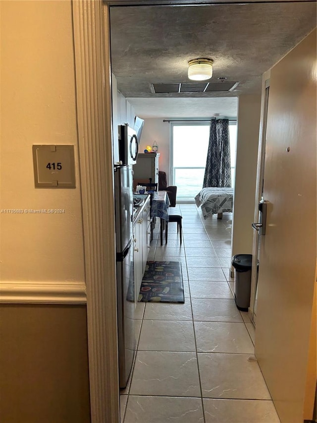 hallway with light tile patterned floors