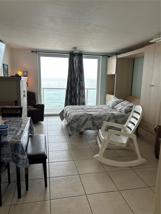 tiled bedroom featuring a water view