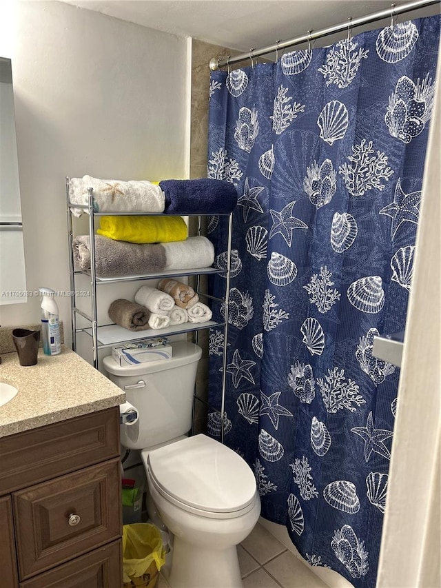 bathroom with tile patterned flooring, vanity, and toilet