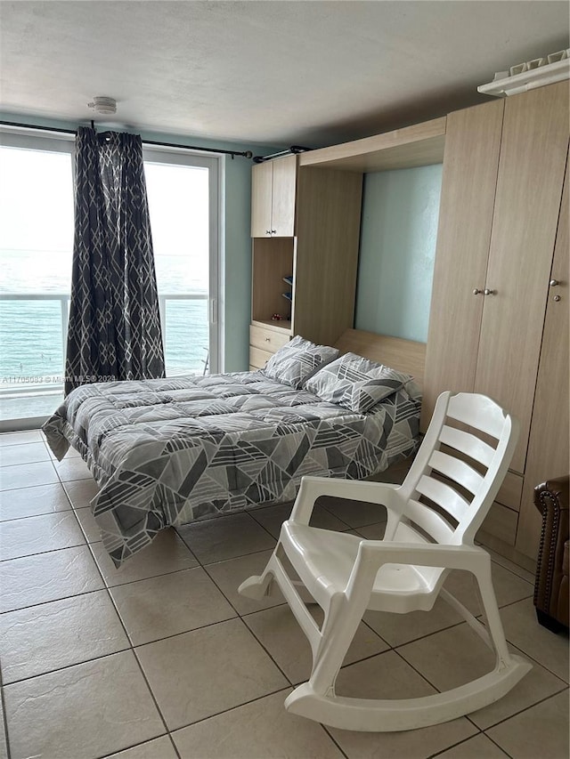 bedroom featuring light tile patterned floors