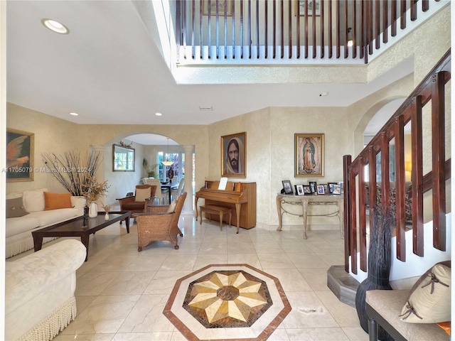 tiled foyer entrance with ornate columns and a notable chandelier