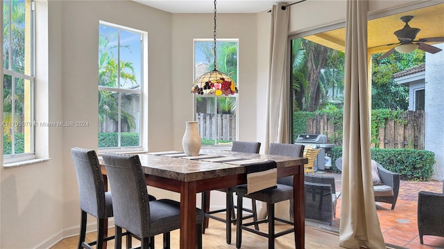 dining room featuring ceiling fan, plenty of natural light, and light tile patterned floors