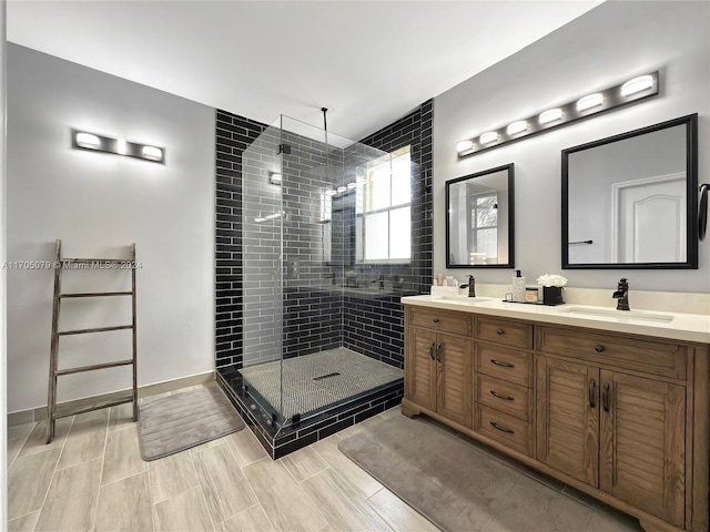 bathroom with vanity and a shower with door