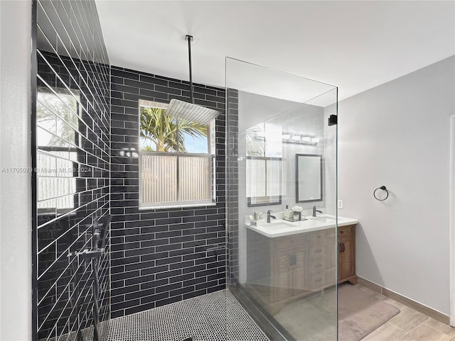 bathroom with hardwood / wood-style flooring, vanity, and tiled shower