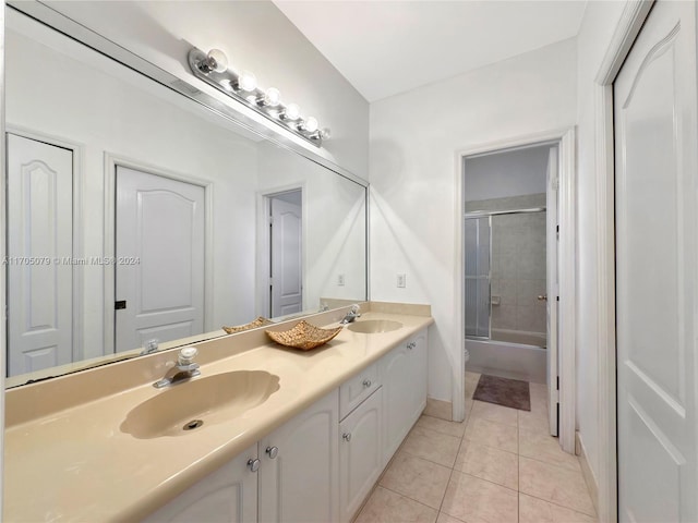 full bathroom featuring tile patterned floors, vanity, toilet, and combined bath / shower with glass door