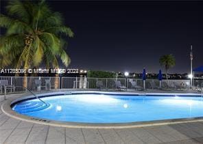 pool at night with a patio