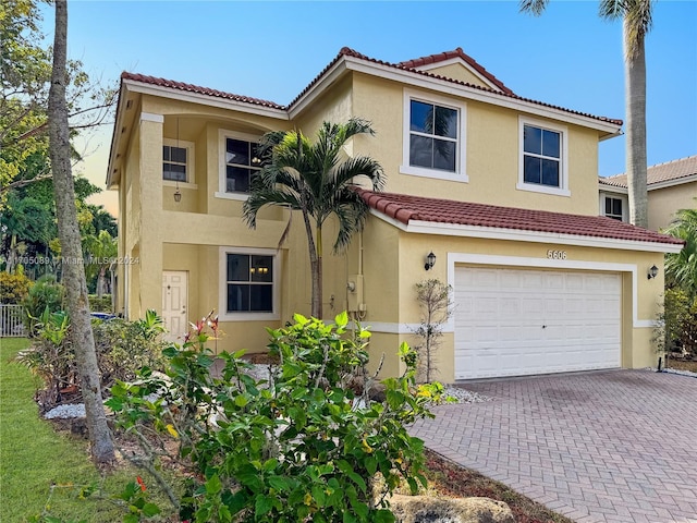 mediterranean / spanish-style home with a garage