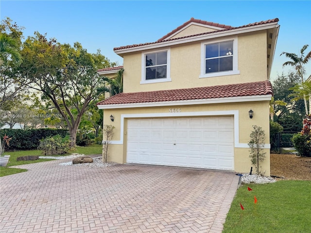 mediterranean / spanish-style house with a garage