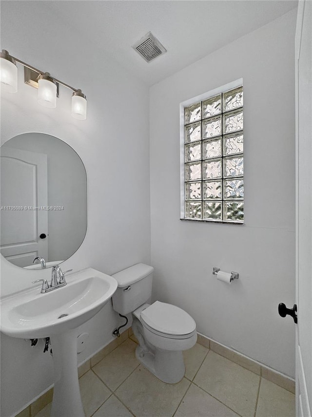 bathroom featuring tile patterned floors and toilet