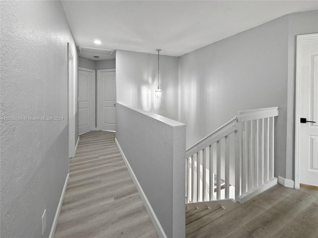 corridor with light hardwood / wood-style floors