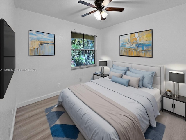 bedroom with ceiling fan and light hardwood / wood-style floors