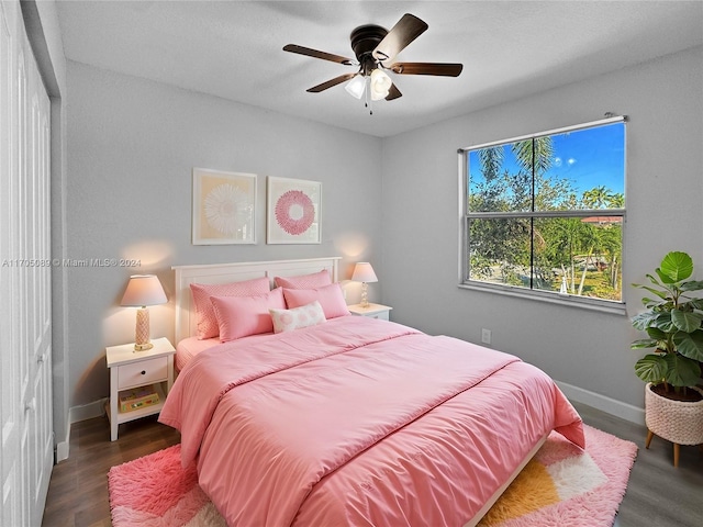 bedroom featuring ceiling fan and dark wood-type flooring