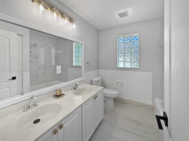 full bathroom featuring vanity, toilet, and tiled shower / bath combo