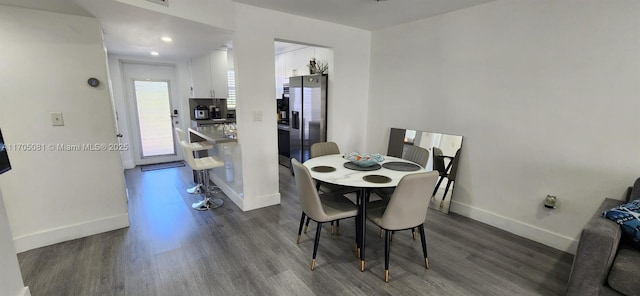 dining space with dark wood-type flooring